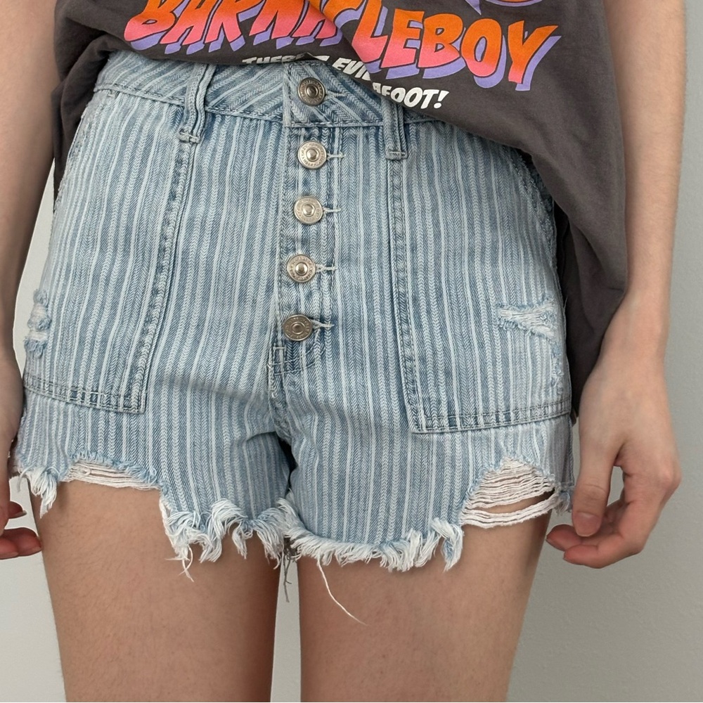 Blue and white striped denim shorts with button fly and frayed hem